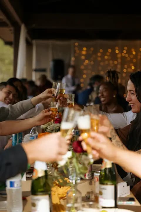 Guests clinking champagne glasses across a reception table